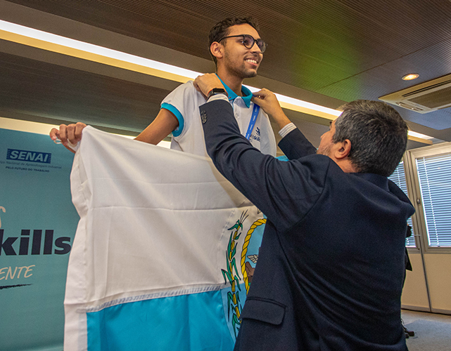 Diretor de Educação da Firjan, Vinícius Cardoso entrega a medalha de 1º lugar ao aluno da Firjan SENAI Tijuca